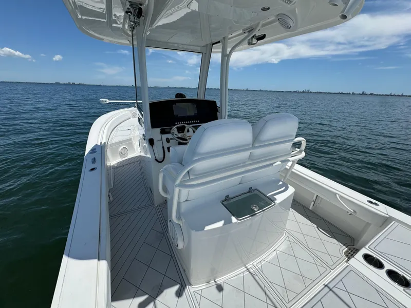 Slide: The Image of 2020 Regulator 26XO boat interior with helm and seating on open water. - 24