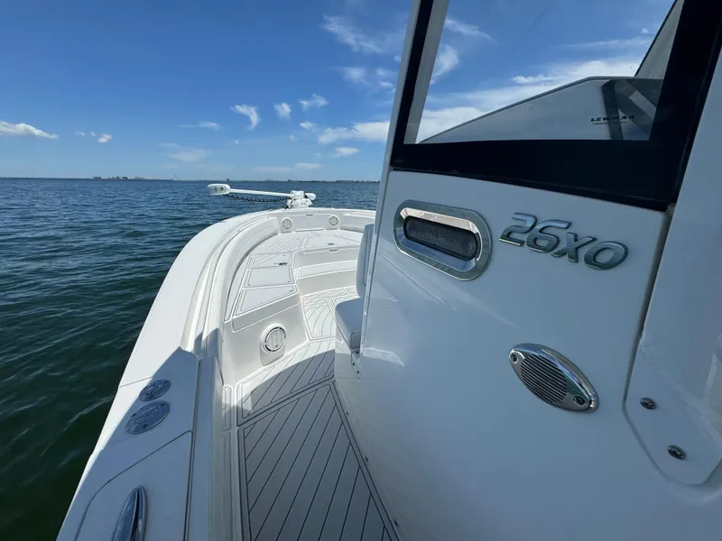 Slide: The Image of 2020 Regulator 26XO boat on calm water with clear blue sky. - 26