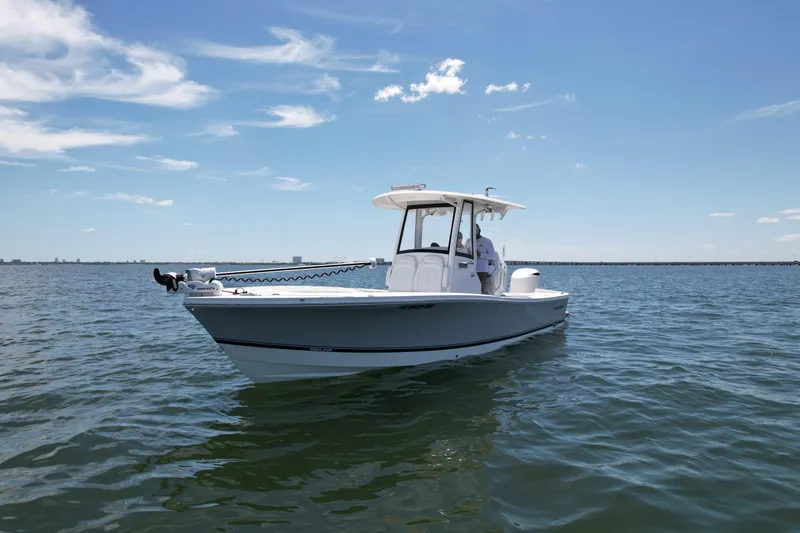 Slide: The Image of 2020 Regulator 26XO boat on calm water under a clear blue sky. - 3