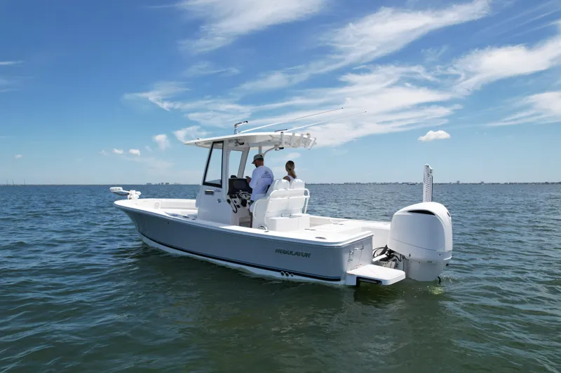 Slide: The Image of 2020 Regulator 26XO boat on open water under clear blue sky. - 5