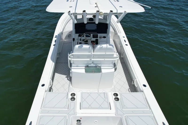 Slide: The Image of 2020 Regulator 26XO boat interior with dual seats and control console on water. - 9