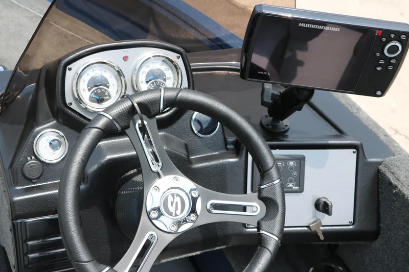 Slide: The Image of 2024 Smoker Craft Excursion Pro 176 SC Pro dashboard with steering wheel and Humminbird fish finder. - 27