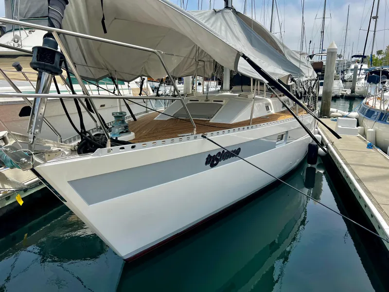 The Image of Sailboat Norseman 400, 1987 model, docked in marina with covered deck and sleek design. - 0