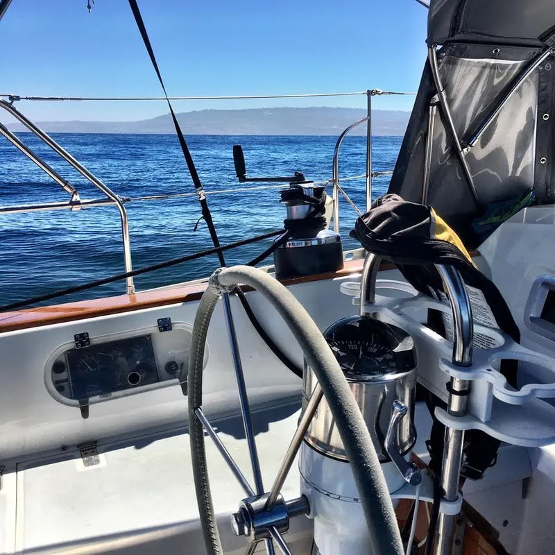Slide: The Image of Sailboat cockpit view on a 1987 Norseman 400, steering wheel and ocean in background. - 10