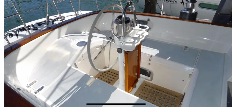 Slide: The Image of Cockpit of 1987 Norseman 400 sailboat with steering wheel and wooden accents. - 12