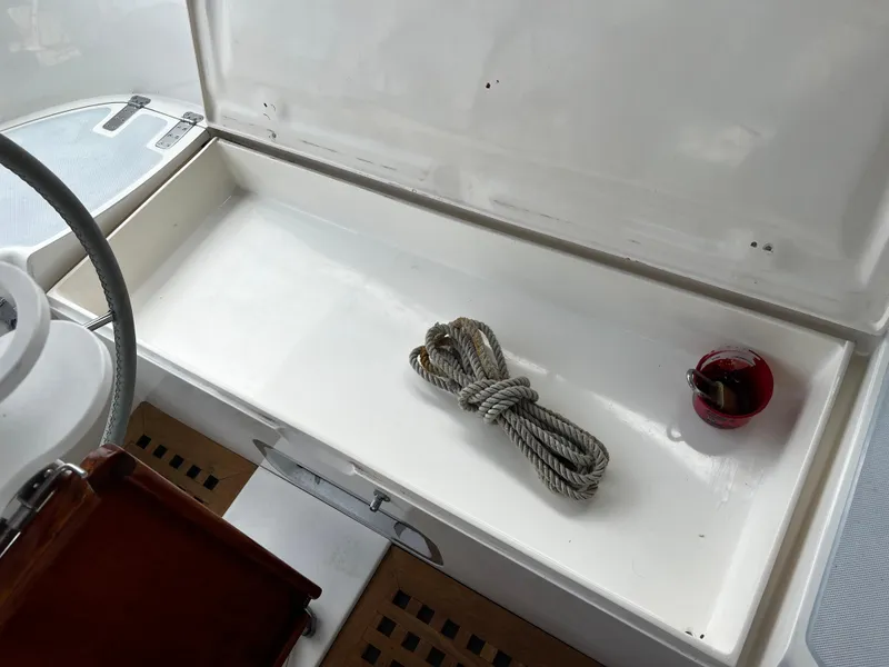 Slide: The Image of 1987 Norseman 400 yacht cockpit storage with rope and red cup. - 16