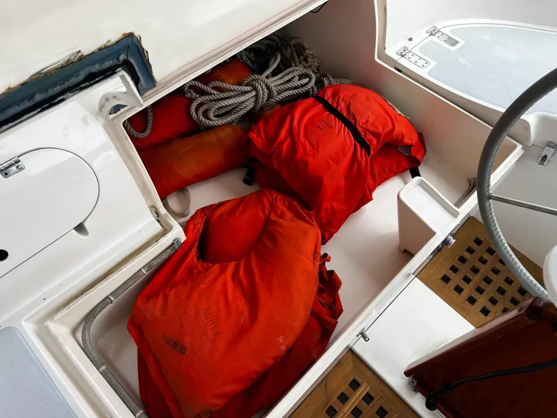 Slide: The Image of Storage compartment on 1987 Norseman 400 sailboat with life jackets and rope. - 18