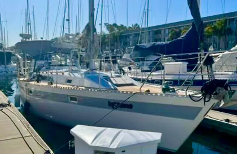 Slide: The Image of 1987 Norseman 400 sailboat docked in a marina, surrounded by other boats. - 2