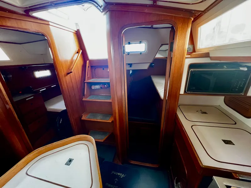 Slide: The Image of Interior of 1987 Norseman 400 sailboat with wooden cabinetry and compact layout. - 25