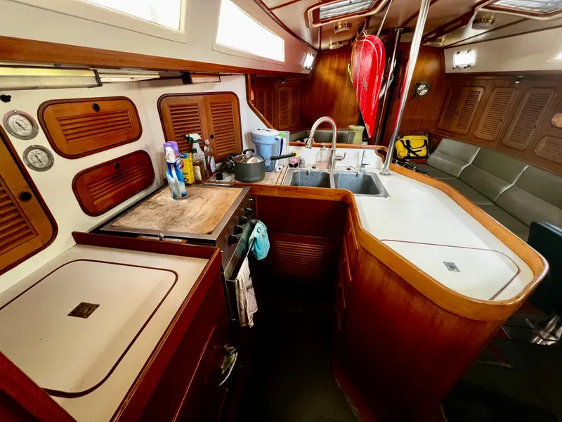 Slide: The Image of 1987 Norseman 400 yacht interior with kitchen, sink, and seating area. - 26