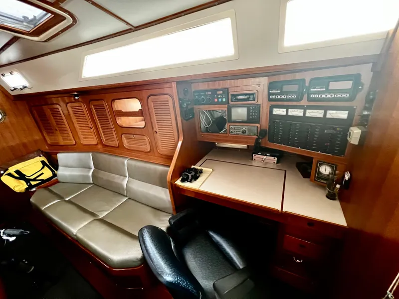 Slide: The Image of 1987 Norseman 400 yacht interior with navigation station and seating area. - 27