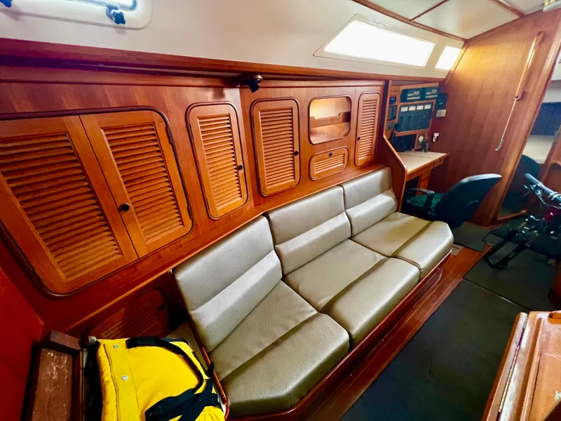 Slide: The Image of 1987 Norseman 400 yacht interior with wooden paneling and cushioned seating. - 29