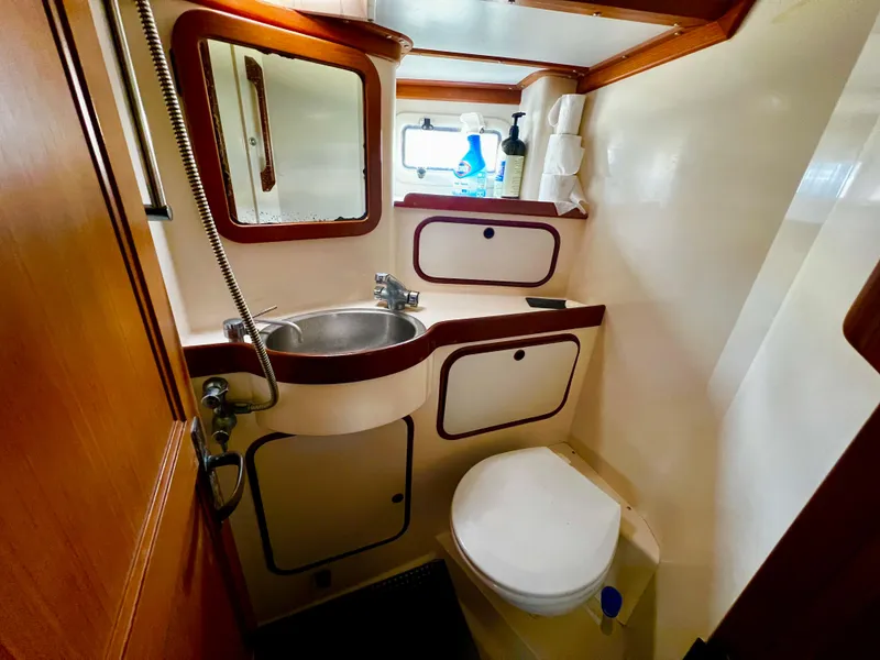 Slide: The Image of Compact bathroom in 1987 Norseman 400 yacht with sink, toilet, and mirror. - 35