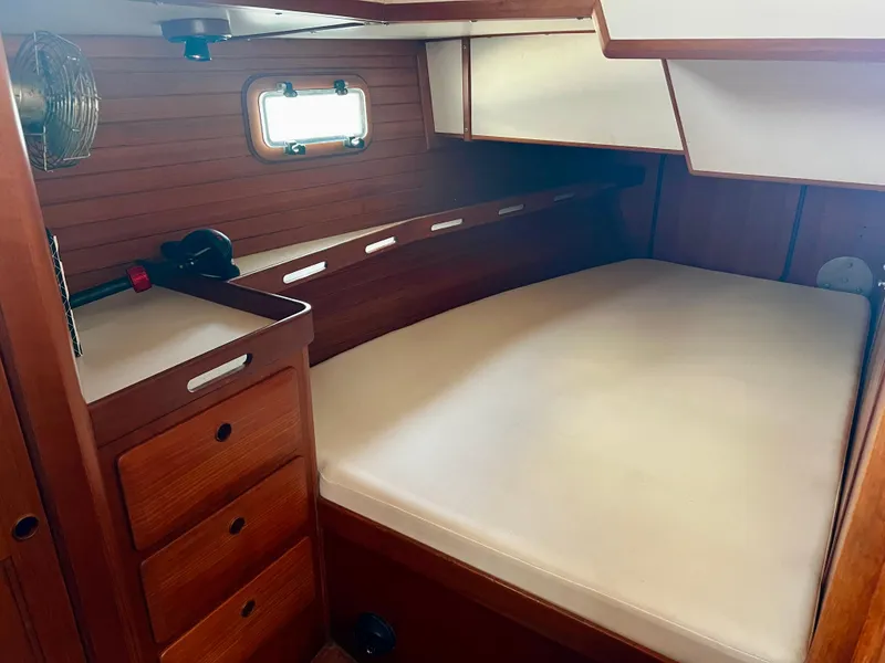 Slide: The Image of Cozy cabin interior of 1987 Norseman 400 sailboat with wooden furnishings and bed. - 36