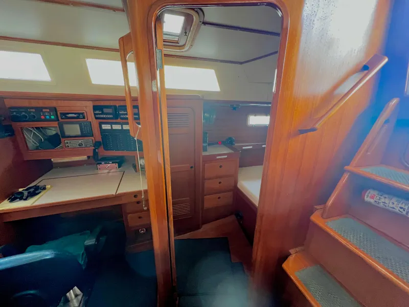 Slide: The Image of Interior of 1987 Norseman 400 sailboat with navigation station and wooden cabinetry. - 37