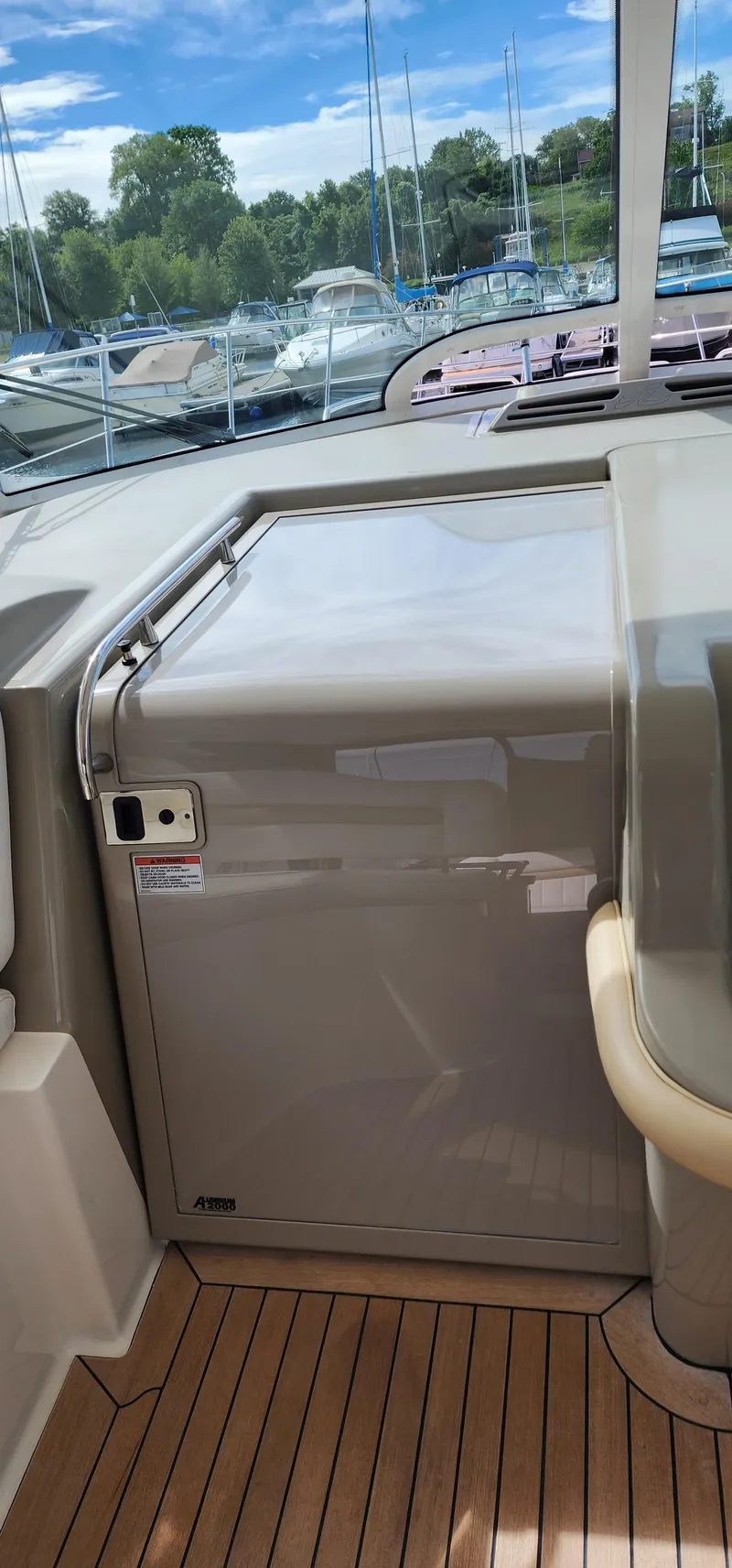 Slide: The Image of 2009 Sea Ray 500 Sundancer interior with sleek cabinetry and wooden flooring. - 10