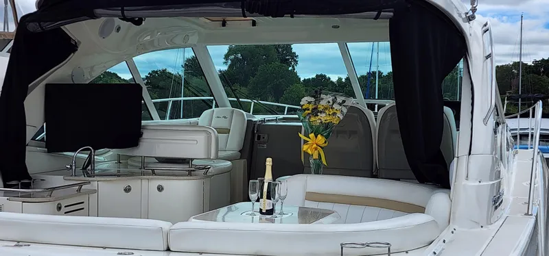 Slide: The Image of 2009 Sea Ray 500 Sundancer yacht interior with seating, table, and champagne. - 14