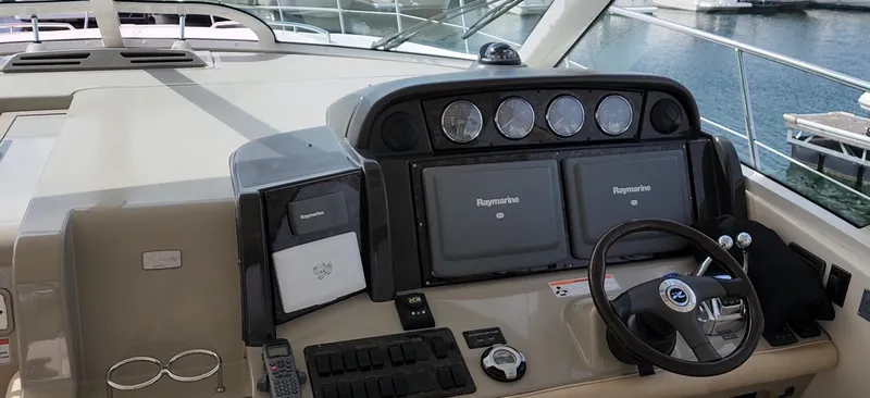 Slide: The Image of 2009 Sea Ray 500 Sundancer helm with navigation displays and steering wheel. - 16