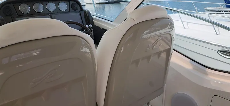 Slide: The Image of Interior view of 2009 Sea Ray 500 Sundancer yacht cockpit with helm and seating. - 17