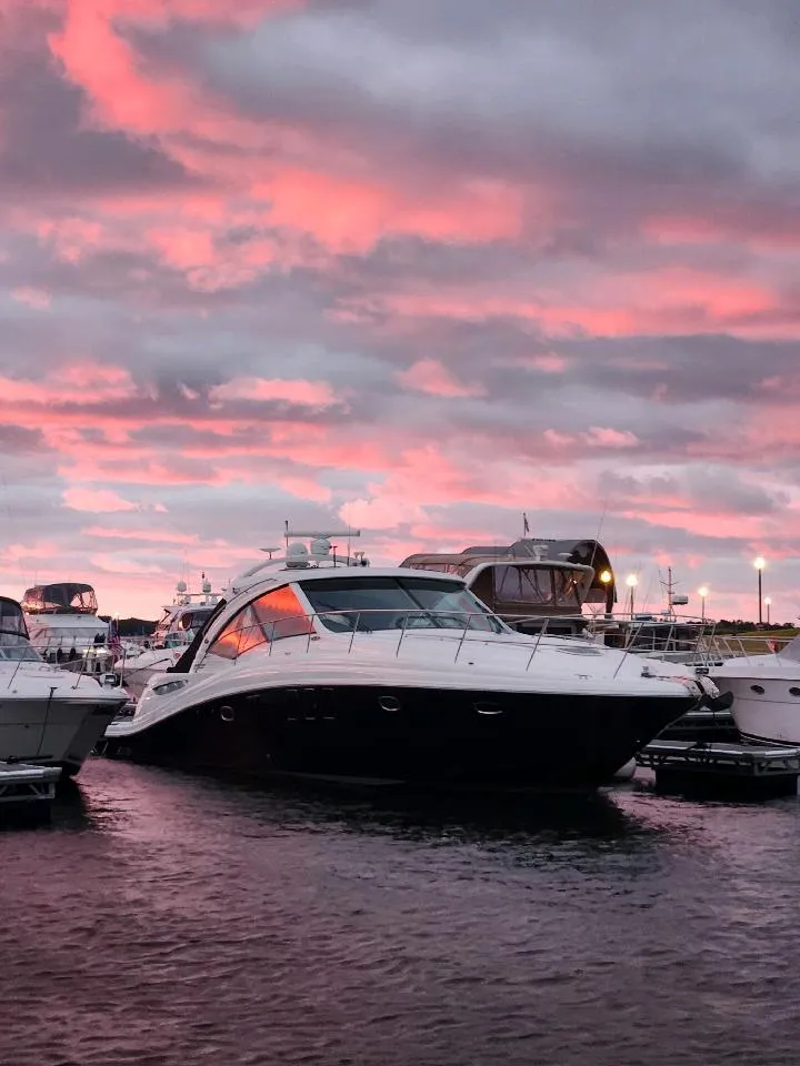 Slide: The Image of 2009 Sea Ray 500 Sundancer yacht docked at sunset with pink clouds. - 2