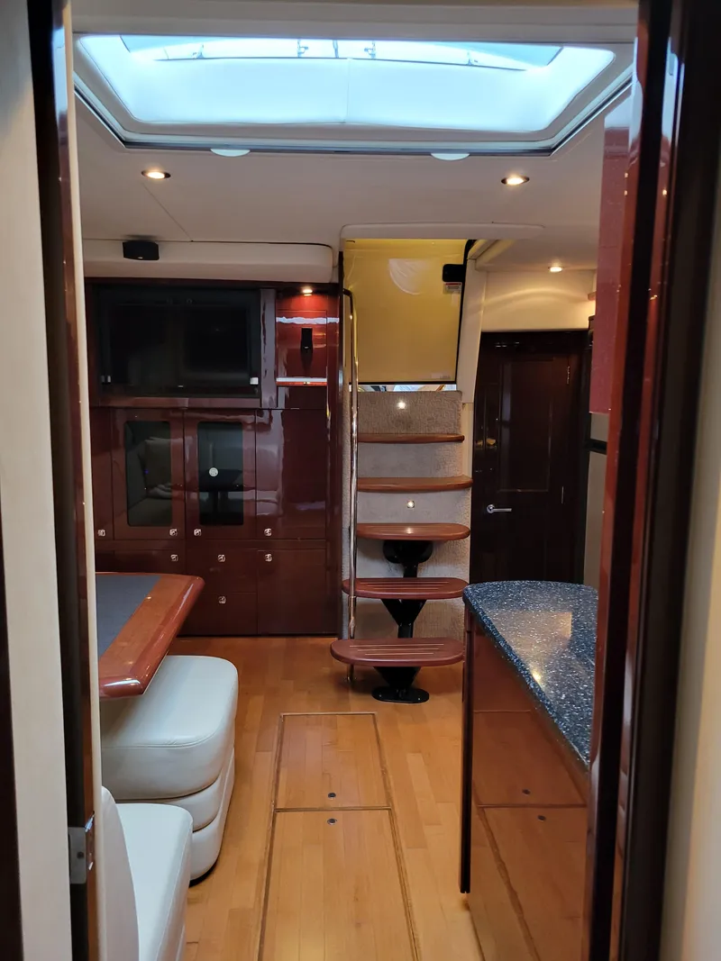 Slide: The Image of Interior of 2009 Sea Ray 500 Sundancer yacht with modern furnishings and skylight. - 27