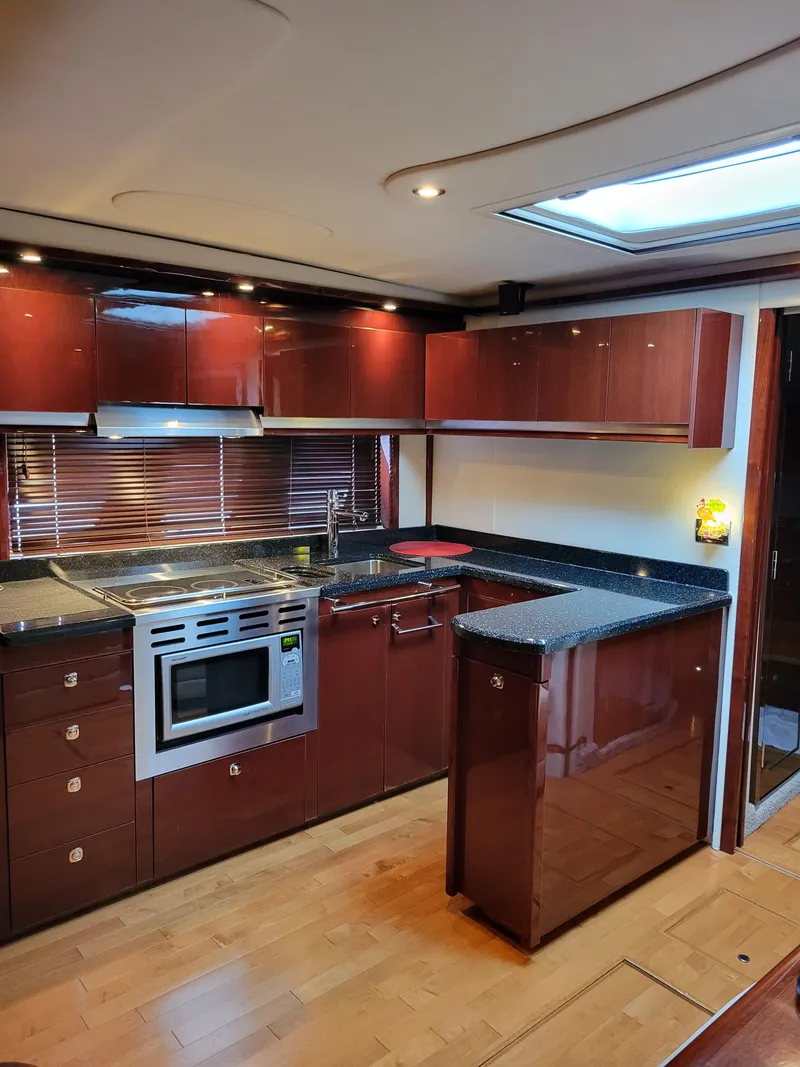 Slide: The Image of Luxurious kitchen interior of 2009 Sea Ray 500 Sundancer yacht with modern appliances. - 28
