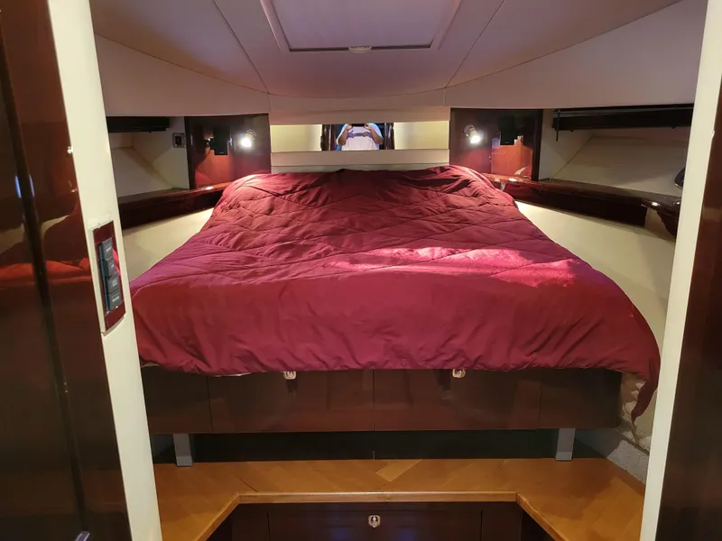 Slide: The Image of Luxurious cabin interior of 2009 Sea Ray 500 Sundancer with cozy bed and ambient lighting. - 36
