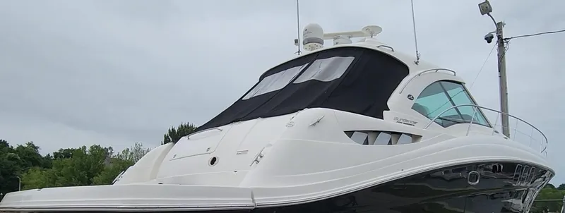 Slide: The Image of 2009 Sea Ray 500 Sundancer yacht with sleek design, docked under cloudy skies. - 41