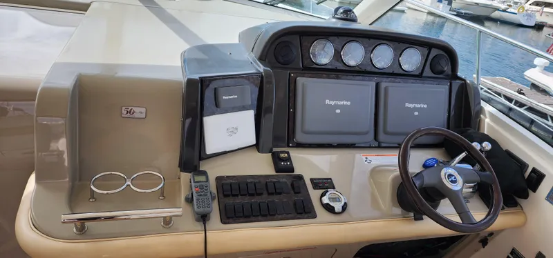 Slide: The Image of 2009 Sea Ray 500 Sundancer helm with navigation equipment and steering wheel. - 9