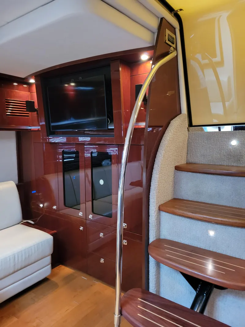 Slide: The Image of Interior of 2009 Sea Ray 500 Sundancer yacht with wooden stairs and modern entertainment area. - 26