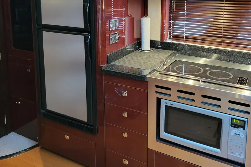 Slide: The Image of Kitchen area of a 2009 Sea Ray 500 Sundancer yacht with modern appliances. - 29