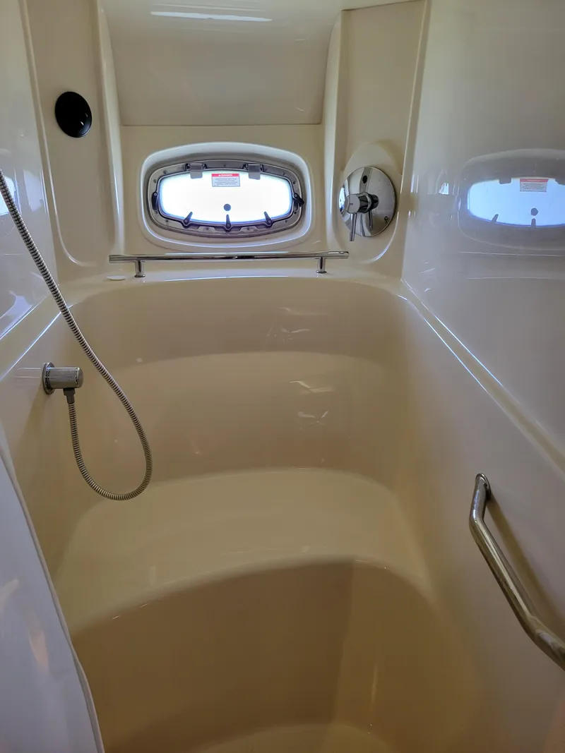 Slide: The Image of 2009 Sea Ray 500 Sundancer shower interior with window and handrail. - 34