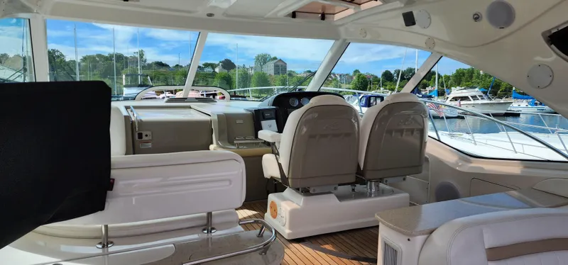 Slide: The Image of Interior view of 2009 Sea Ray 500 Sundancer yacht with luxurious seating and helm. - 8
