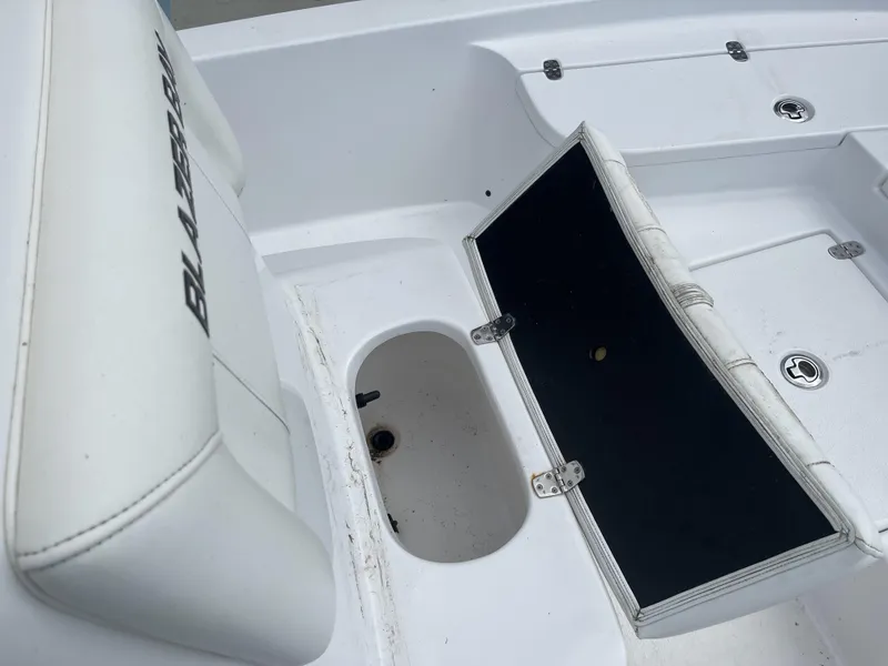 Slide: The Image of 2020 Blazer boat interior with open storage compartment and cushioned seating. - 10