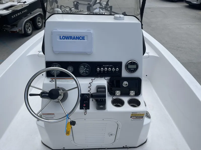 Slide: The Image of 2020 Blazer boat dashboard with Lowrance GPS, steering wheel, and control panel. - 11