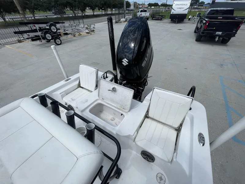Slide: The Image of 2020 Blazer boat with Suzuki outboard motor and seating, parked in a lot. - 12