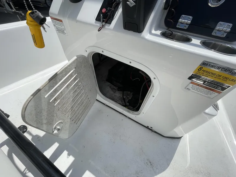 Slide: The Image of Open storage compartment on a 2020 Blazer boat, showing interior and capacity label. - 31