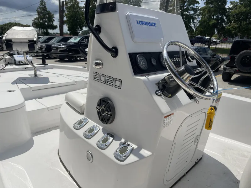 Slide: The Image of 2020 Blazer boat console with steering wheel and Lowrance electronics, parked outdoors. - 33