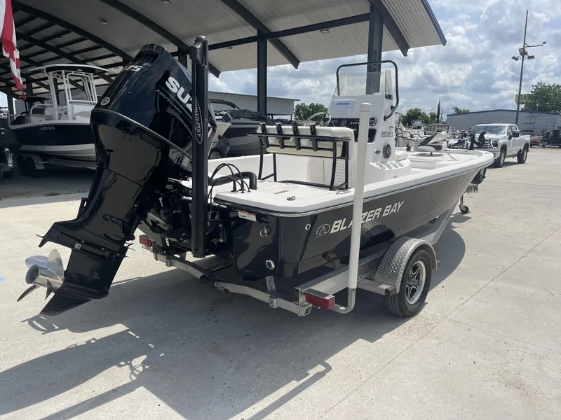 Slide: The Image of 2021 Blazer Bay 2020 boat with Suzuki outboard motor on trailer. - 6