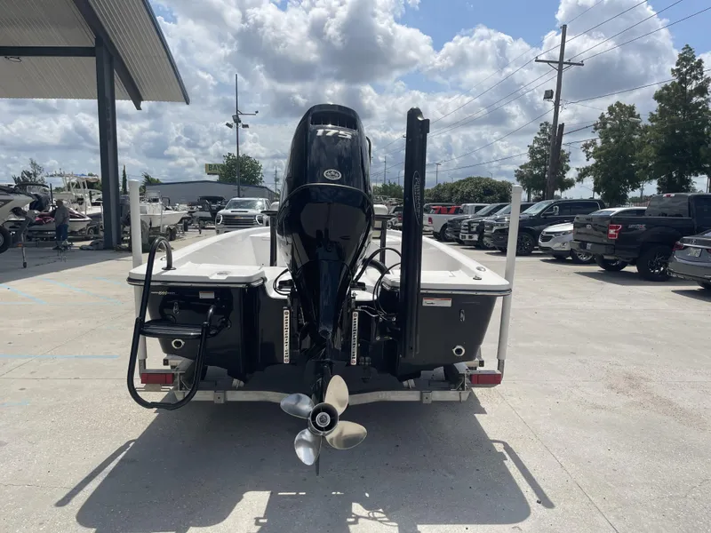 Slide: The Image of 2020 Blazer boat with 175 HP engine at a dealership, rear view. - 7