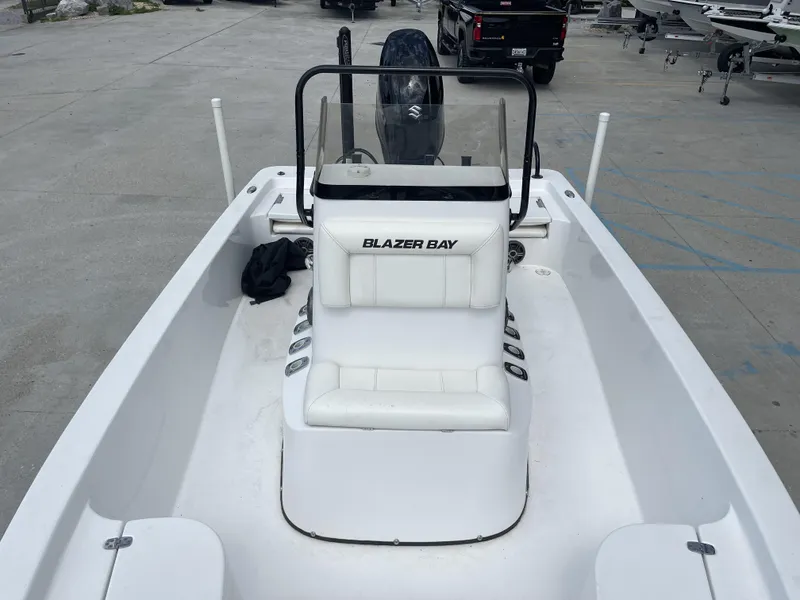 Slide: The Image of Blazer Bay 2020 model boat, white interior, parked on concrete lot, rear view. - 9
