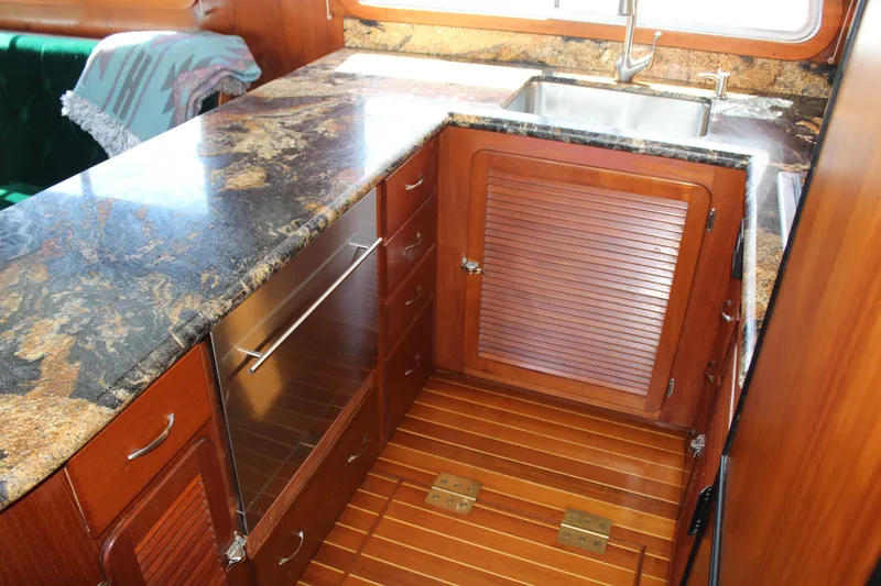 Slide: The Image of Cherubini Independence 50 yacht kitchen, 1999 model, featuring wood cabinets and granite countertop. - 44