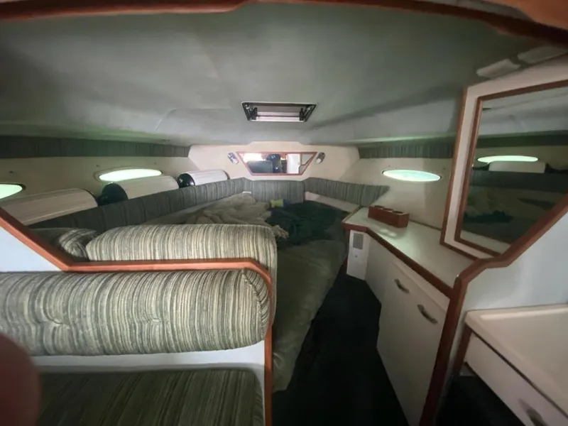 Slide: The Image of Interior cabin of a 1989 Sea Ray '30 Sundancer with cozy seating and storage. - 3