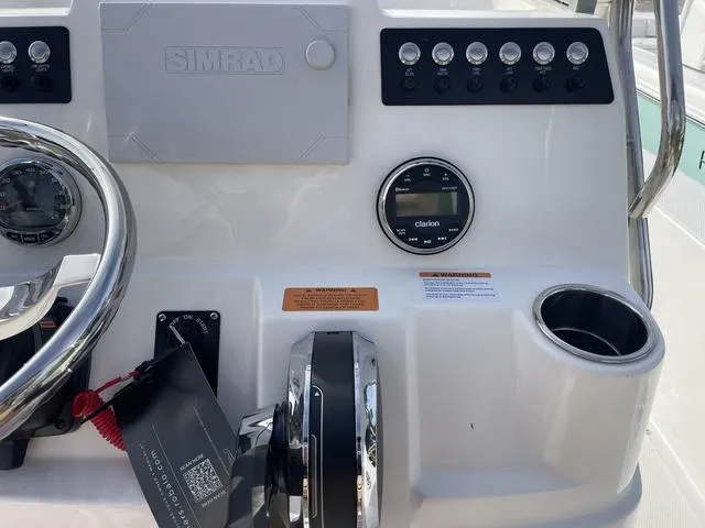 Slide: The Image of Control panel of a 2024 Robalo 206 Cayman boat with Simrad and Clarion systems. - 15