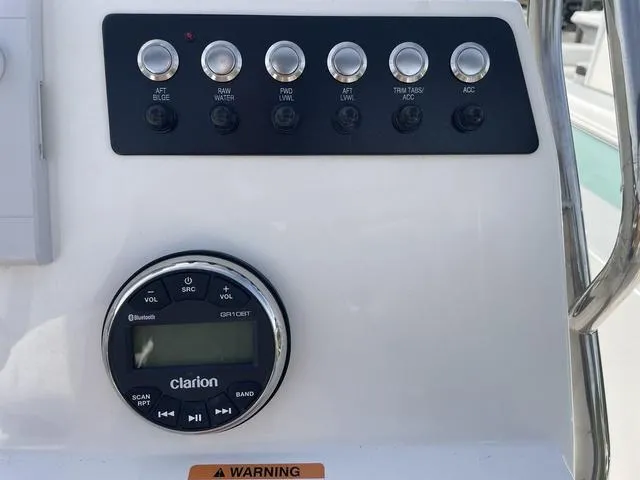 Slide: The Image of Control panel of 2024 Robalo 206 Cayman boat with Clarion audio system. - 16