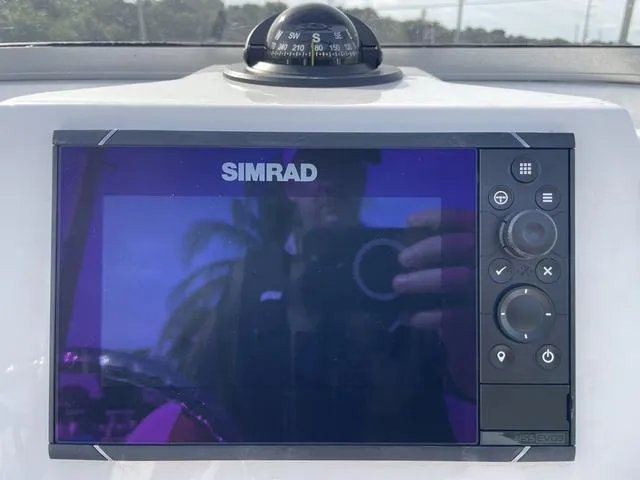 Slide: The Image of Simrad navigation system on 2024 Robalo 206 Cayman boat dashboard. - 17