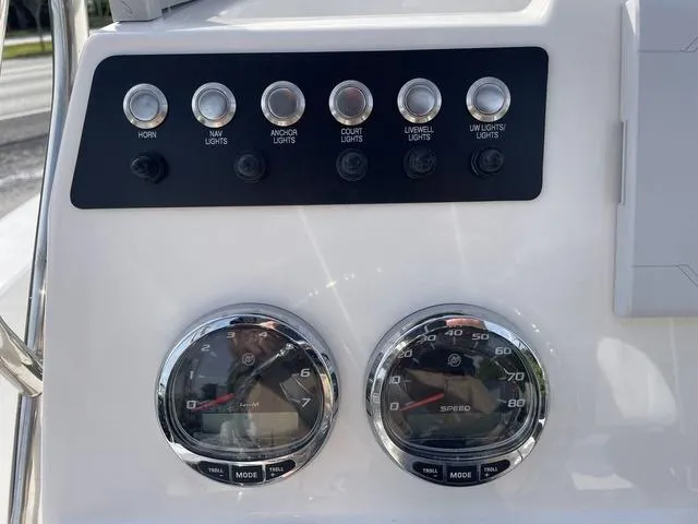 Slide: The Image of Dashboard controls and gauges of a 2024 Robalo 206 Cayman boat. - 18
