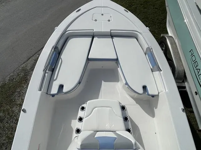 Slide: The Image of 2024 Robalo 206 Cayman boat interior with cushioned seating and storage compartments. - 19