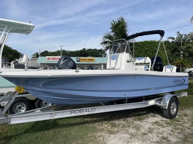 Slide: The Image of 2024 Robalo 206 Cayman boat on a trailer, displayed outdoors. - 2