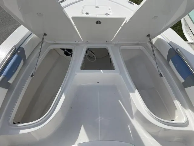 Slide: The Image of 2024 Robalo 206 Cayman boat storage compartments open. - 27